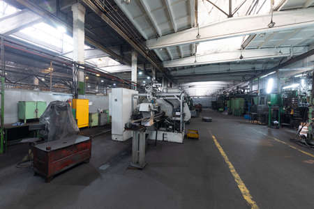 The interior of a big industrial building of factory with steel constructions. Plant of car...