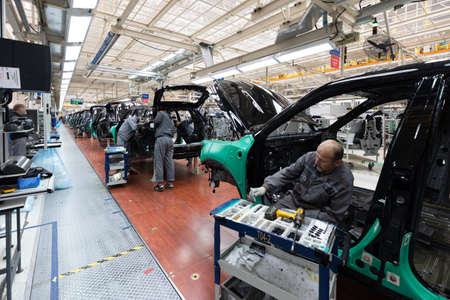 Minsk, Belarus - Dec 15, 2021: Car bodies are on assembly line. Factory for production of cars. Modern automotive industry. A car being checked before being painted in a high-tech enterpriseのeditorial素材