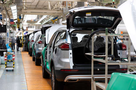 Car bodies are on assembly line. Factory for production of cars. Modern automotive industry....