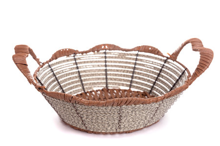 knitted basket with metal inserts and handles on a white backgroundの写真素材