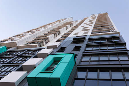 stylish residential apartment building against the blue sky bottom view
