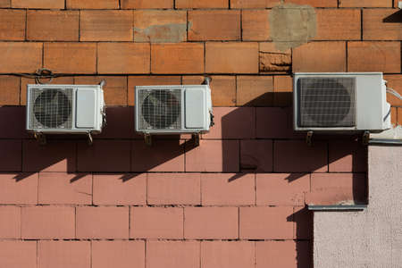 block of climatic equipment of the air conditioner hanging outside the building