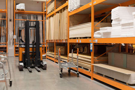 interiors of a shop selling lumber and planks with a loader in the middle