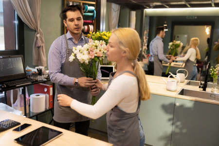 Two florists at work in a flower shopの写真素材