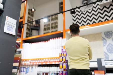 the buyer chooses ceramic tiles in the bathroomの写真素材