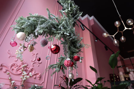 composition of natural pine needles hanging from the ceiling with Christmas decorations in the...
