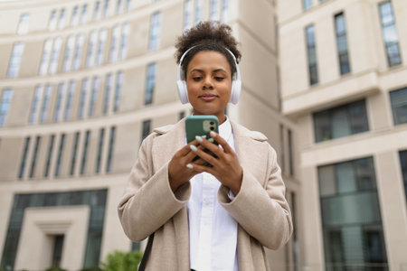 african american woman Expert of an insurance company with a mobile phone against the background of a business centerの写真素材