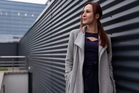 portrait of a successful self-sufficient businesswoman in front of a stylish office building,...