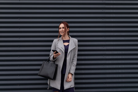 portrait of a business woman on a gray embossed wall