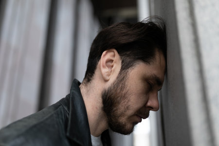 close-up portrait of a sad man suffering from depression and migraineの写真素材