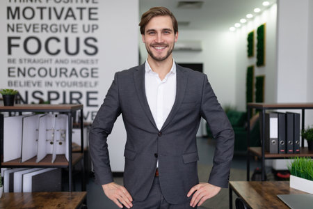 portrait of a successful manager in a business suit in the middle of the office