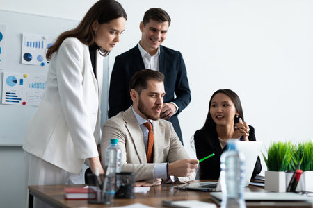 Smiling diverse colleagues gather in boardroom brainstorm discuss financial statistics together