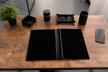 workplace in the office with a leather folder for papers on the table
