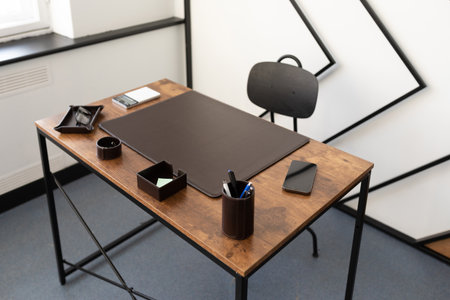 desktop space in the office with leather stationery accessories and brown color bevarの写真素材
