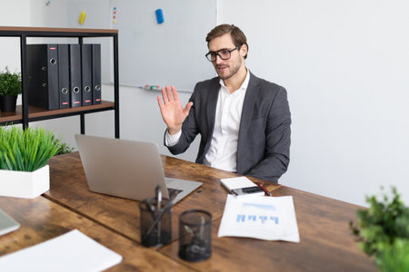 stylish business woman sitting on a chair with a phone in her hands in the middle of the office