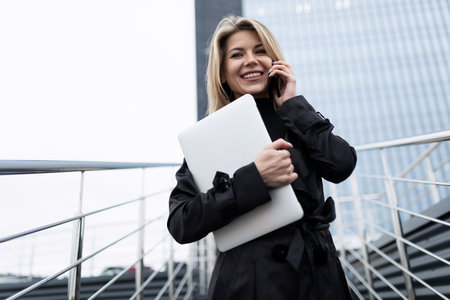 optimist woman stands against the backdrop of a financial bankの写真素材