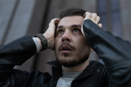 depressed man holding his head