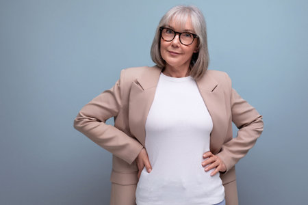 60s middle aged business woman with gray hair in a stylish image on a bright background with copy...