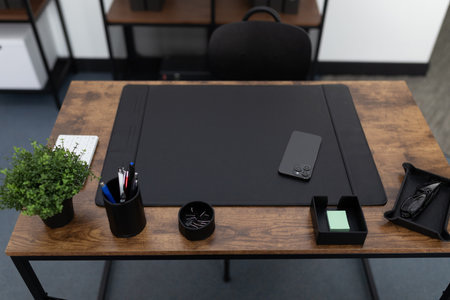 graphic designer desk workspace in office with plant on tableの写真素材