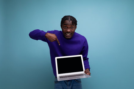 IT specialist african young brunette man with dreadlocks with laptopの写真素材