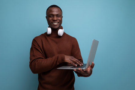 successful african businessman demonstrating his projects using laptopの写真素材