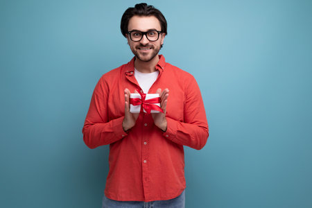 cute happy young brunette man got a lovely birthday presentの写真素材