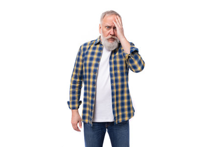 well-groomed 60s middle-aged gray-haired retired man with a mustache and beard is going through