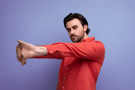 well-groomed smart 35 year old brunette millennial man with gorgeous hair stretches his armsの写真素材