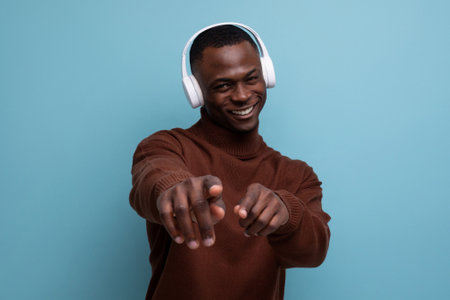 25 year old young American man with big white wireless headphones in front of copy spaceの写真素材