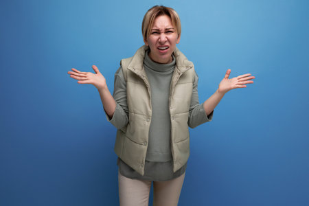 indignant sad blonde young millennial woman on studio background