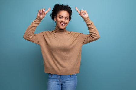 isolated background, well groomed pretty young brunette hispanic woman with ponytail hairstyleの写真素材