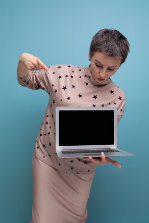 young pretty business woman with childish features with short hair showing blank screen for advertising posterの写真素材