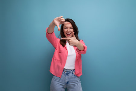 cheerful brunette young female adult in a shirt with joyful emotions on an isolated background