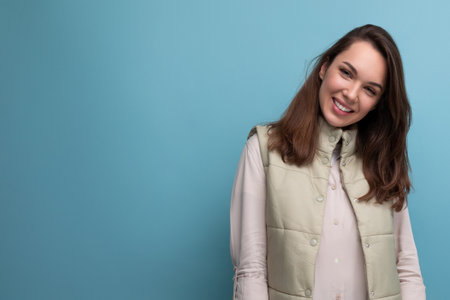 brunette woman with Hollywood smile posing on blue backgroundの写真素材