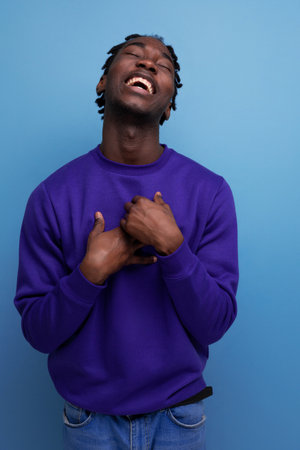 handsome african young guy with dreadlocks smiling and jokingの写真素材