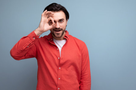 handsome brutal young brunette man in red shirtの写真素材