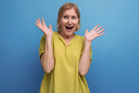 blond frightened mature woman waving her arms