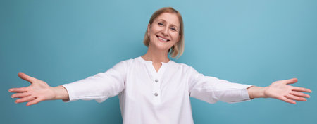 healthy slim blond mature woman in menopause age in studio backgroundの写真素材