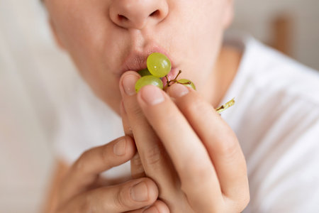 woman eating fruit during snackの写真素材
