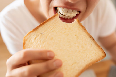 woman enjoying a bread snackの写真素材