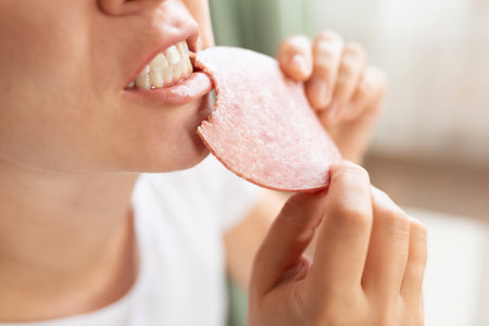the woman is hungry and therefore eats sausage