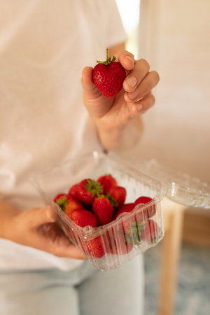hands holding juicy red strawberriesの写真素材