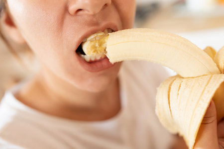 woman eating banana while having a breakdownの写真素材