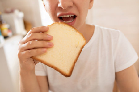 woman having breakfast while dieting with toasted breadの写真素材