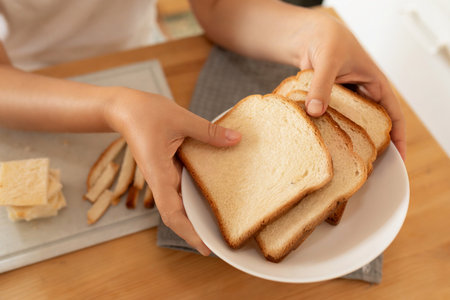 the woman put slices of bread on a plate
