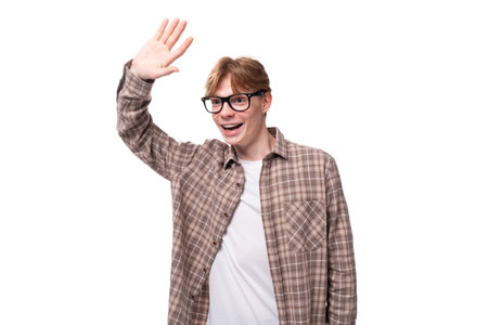 young charming student guy with red hair in glasses looks friendlyの写真素材