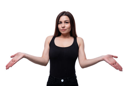 Young stylish woman with black hair wearing a black off-shoulder T-shirt on a white backgroundの写真素材