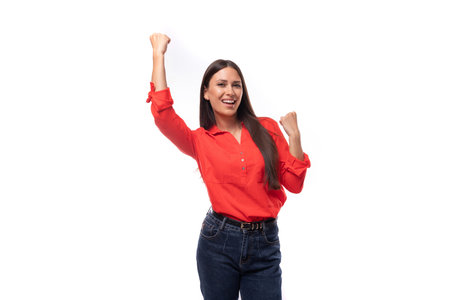 young energetic active brunette assistant woman dressed in a red blouse on a white background with copy spaceの写真素材