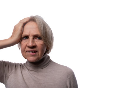 Portrait of an excited senior woman with gray hair on a background with copy spaceの写真素材