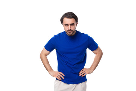 portrait of a young smart caucasian brunette man with a beard in a blue t-shirt